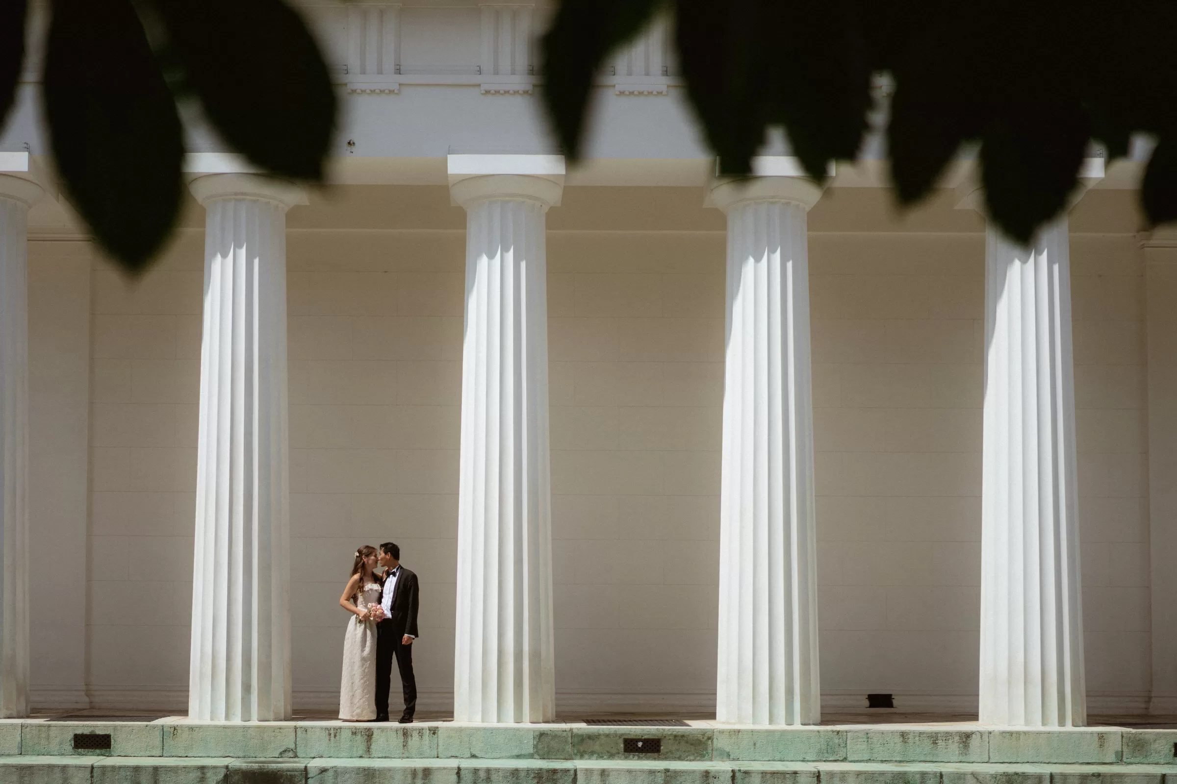 Elegant couple between columns of Theseus Temple in Vienna
