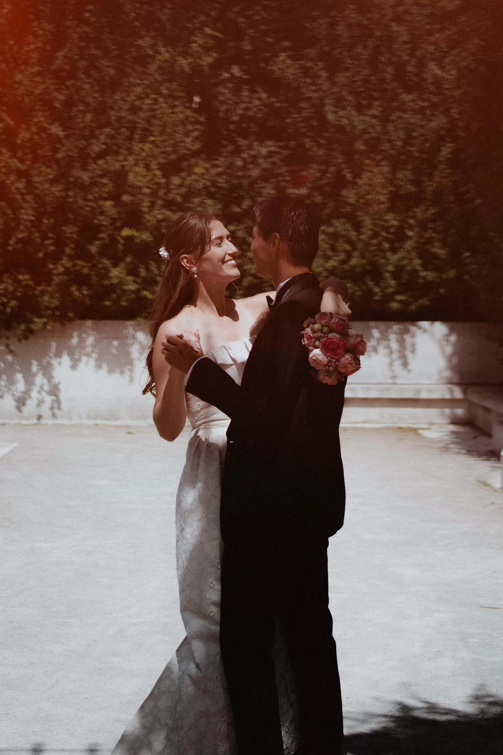 Couple dancing under bright sunlight in Volksgarten in Vienna