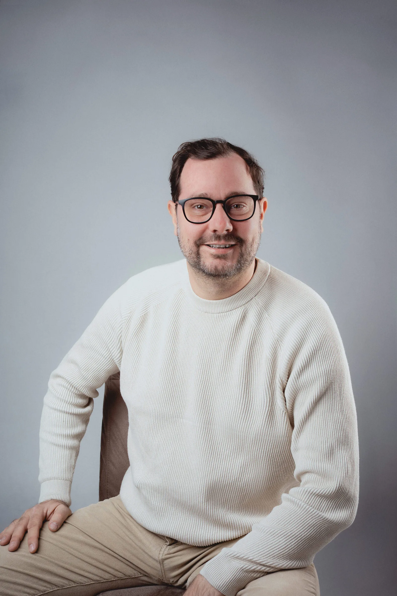 Business portrait of a man in front of a grey background