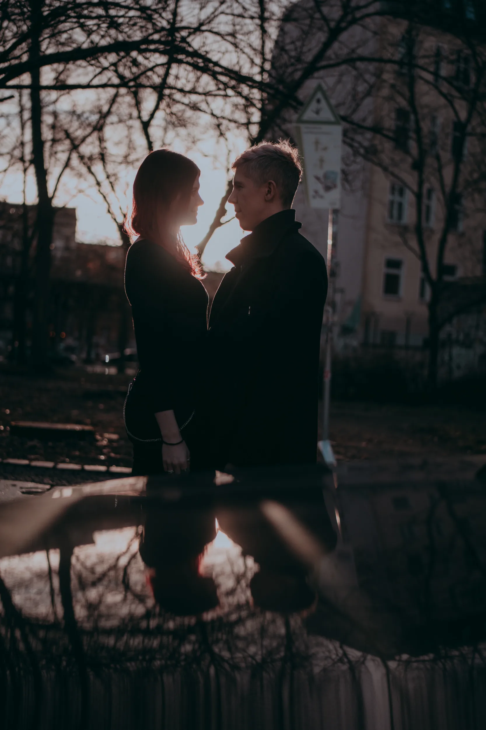Couple kissing in a park next to Schlesisches Tor in Berlin, a dramatic photo by Fedor Vasilev