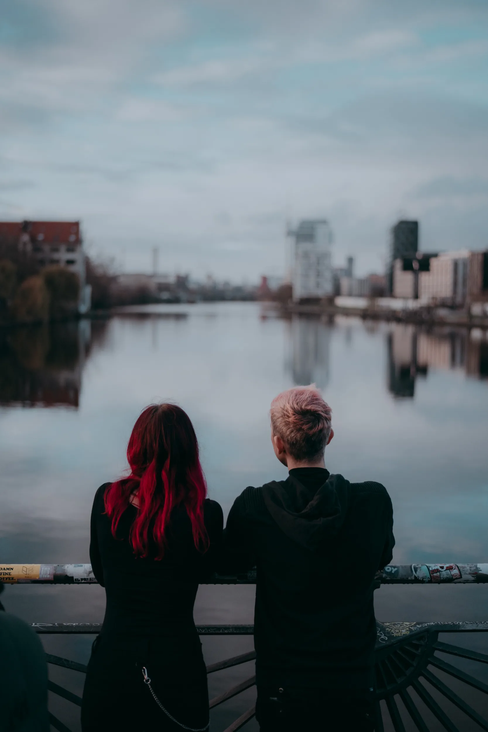 Couple standing on Oberbaumbrücke in Berlin and looking at the view on a beautiful sunny day