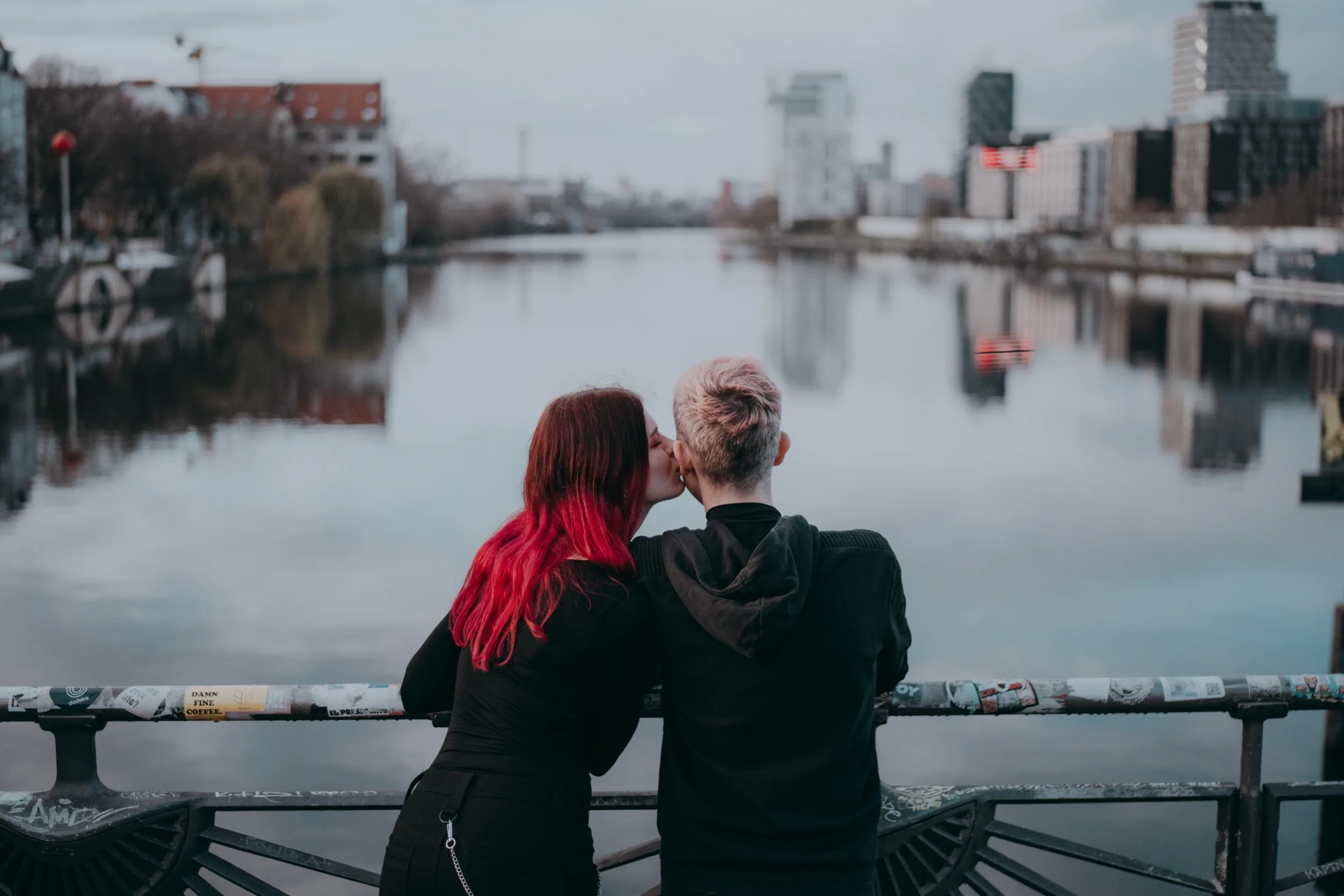 couple on Oberbaumbrücke in Berlin with the view on Spree; a romantic moment on a pieceful day