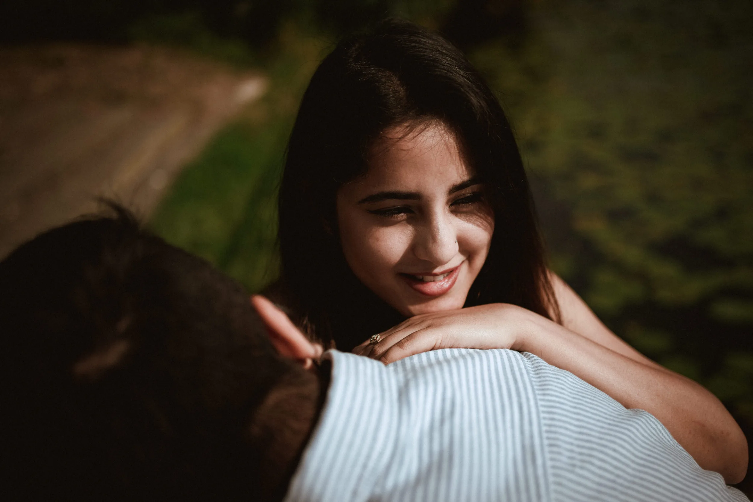 Couple having intimate moment in a park by the water cinematic photography by Fedor Vasilev