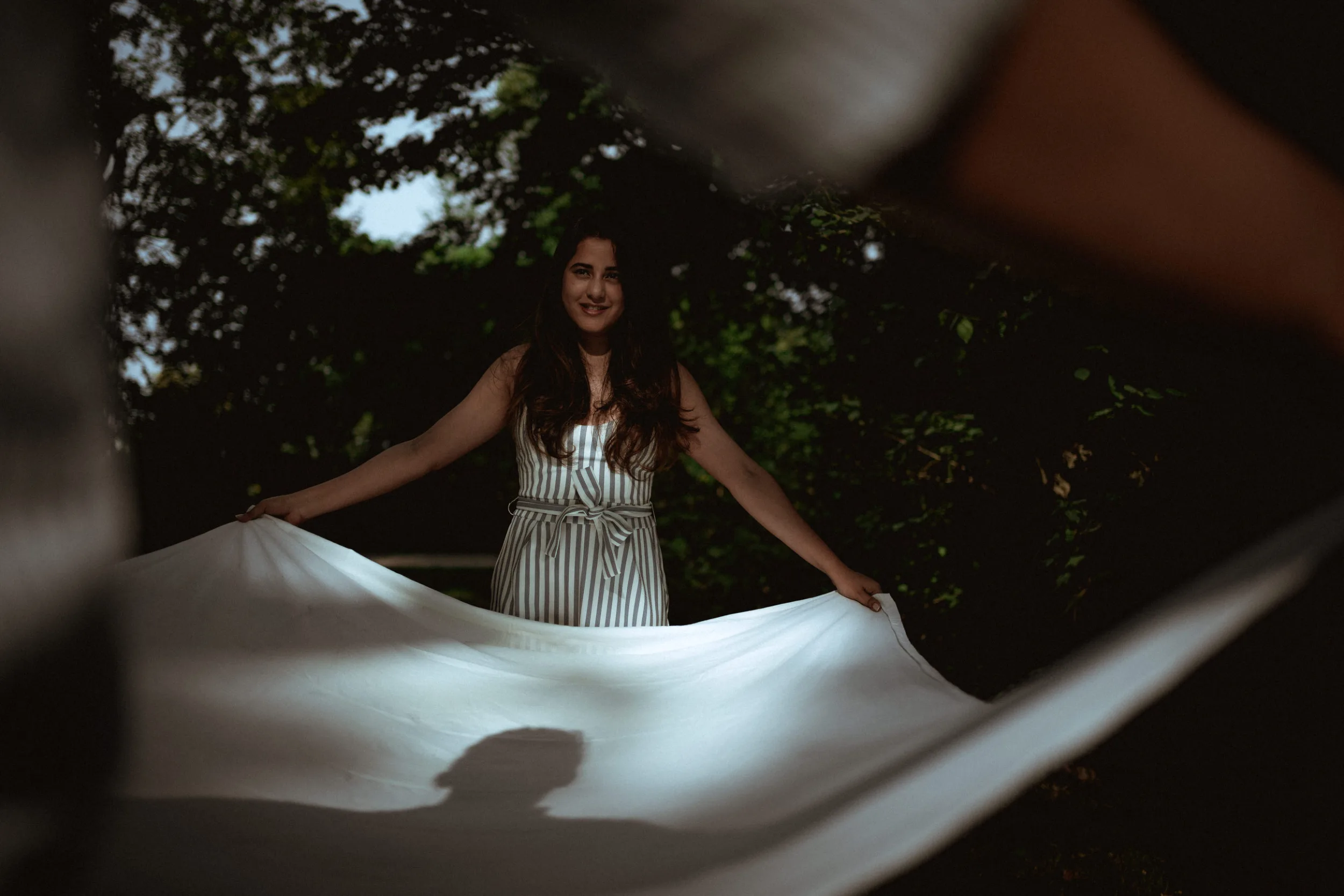 A couple putting down a picnic cloth in a park