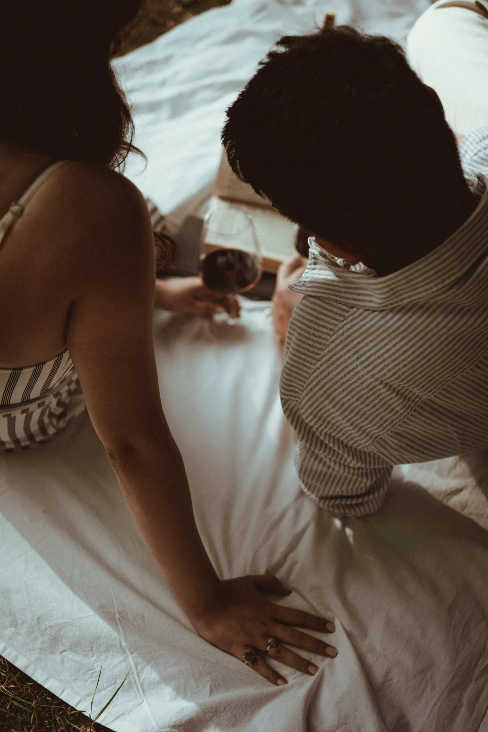 A couple spending time together in a park reading a book