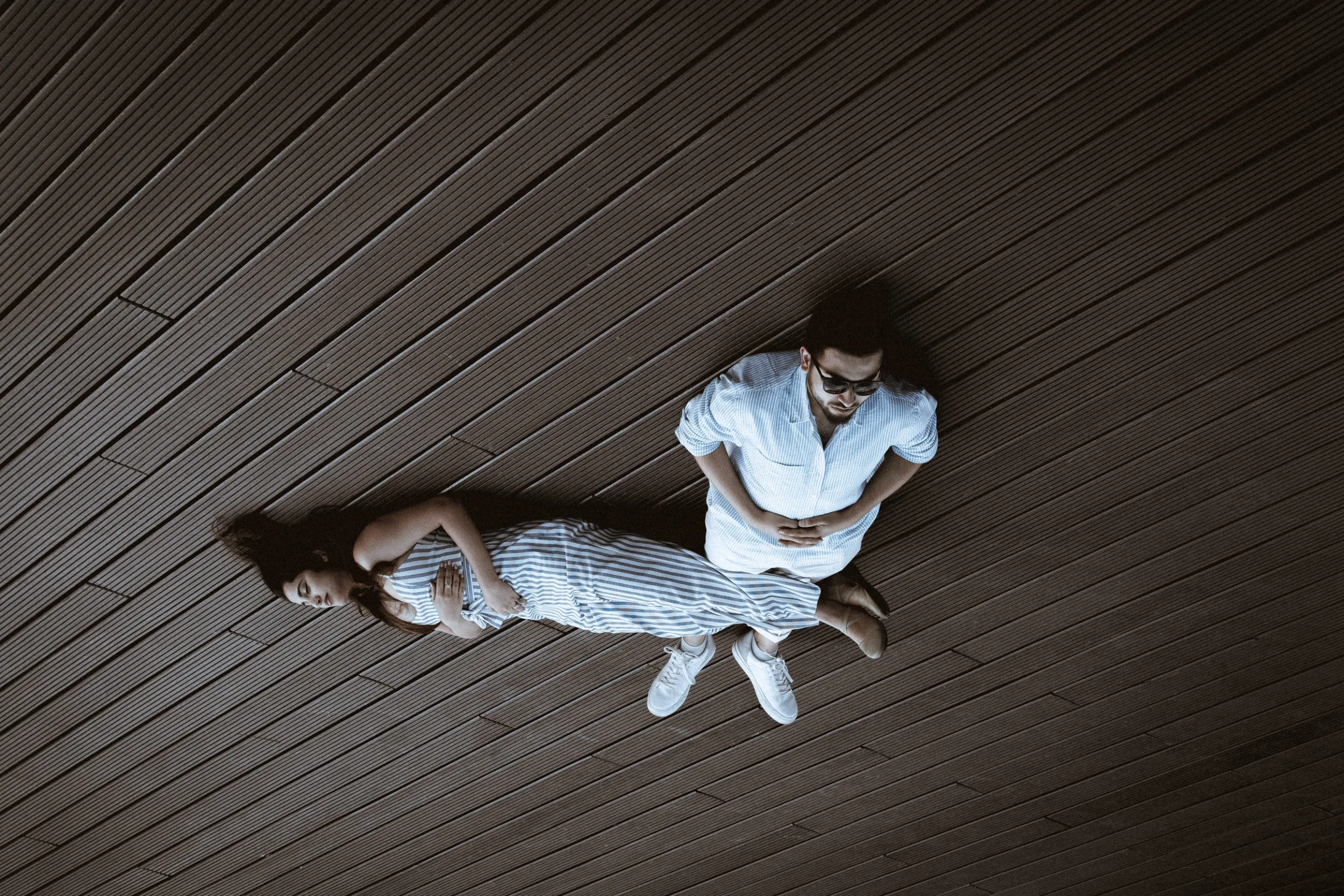 A couple laying on a wooden floor on tempodrom in berlin