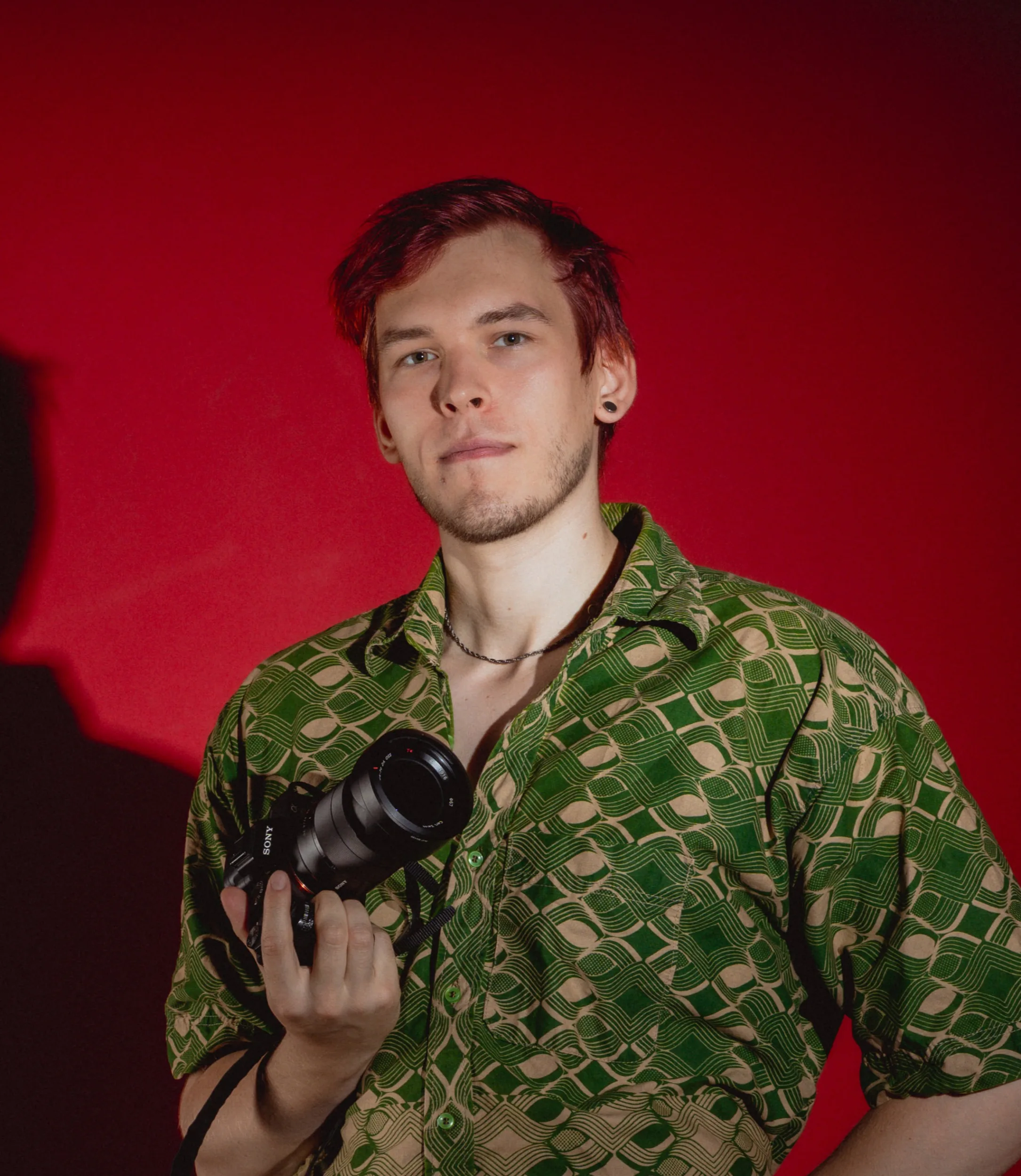 Fedor Vasilev Photographer in a studio in front of red background