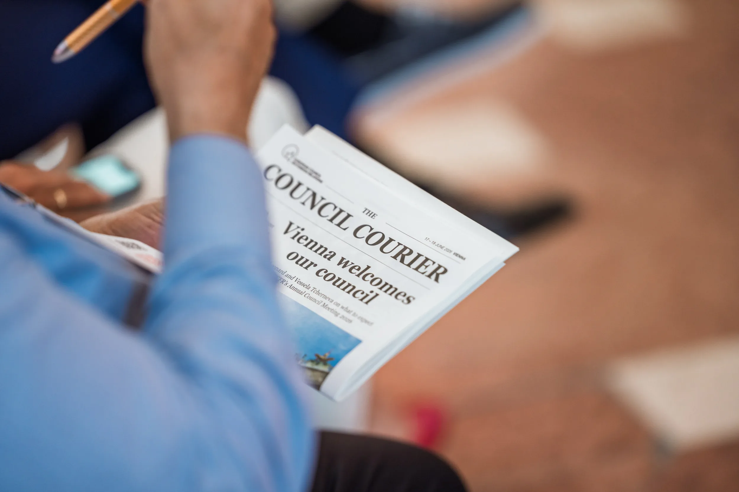 European Council on Foreign Relations Annual Council Meeting | Institutional Event Photographer Fedor Vasilev Photographer In Berlin a person reading a conference brochure in a form of a newspaper