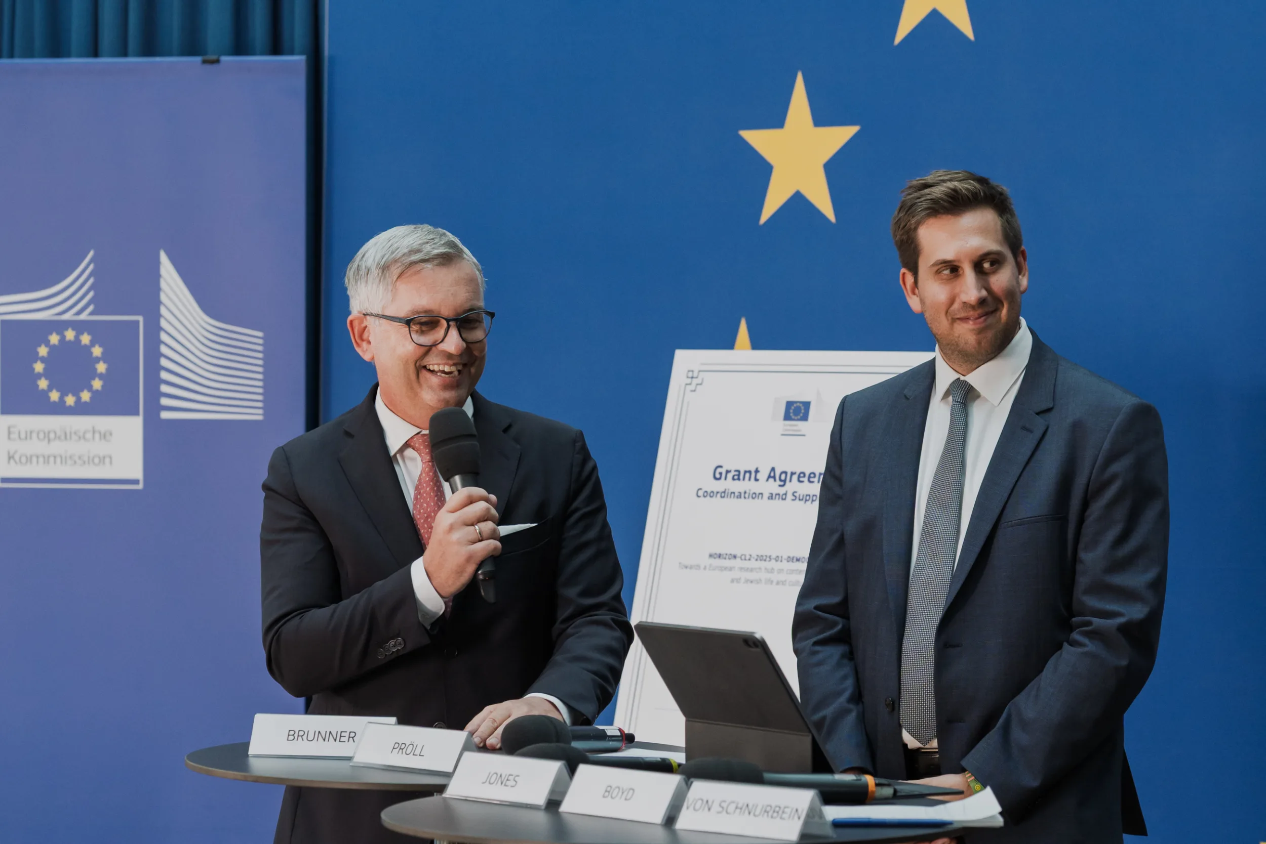 European Union Event Photographer | Grant Signing Ceremony in Vienna Fedor Vasilev Photographer In Berlin European representative speaking during a ceremony in a modern event room