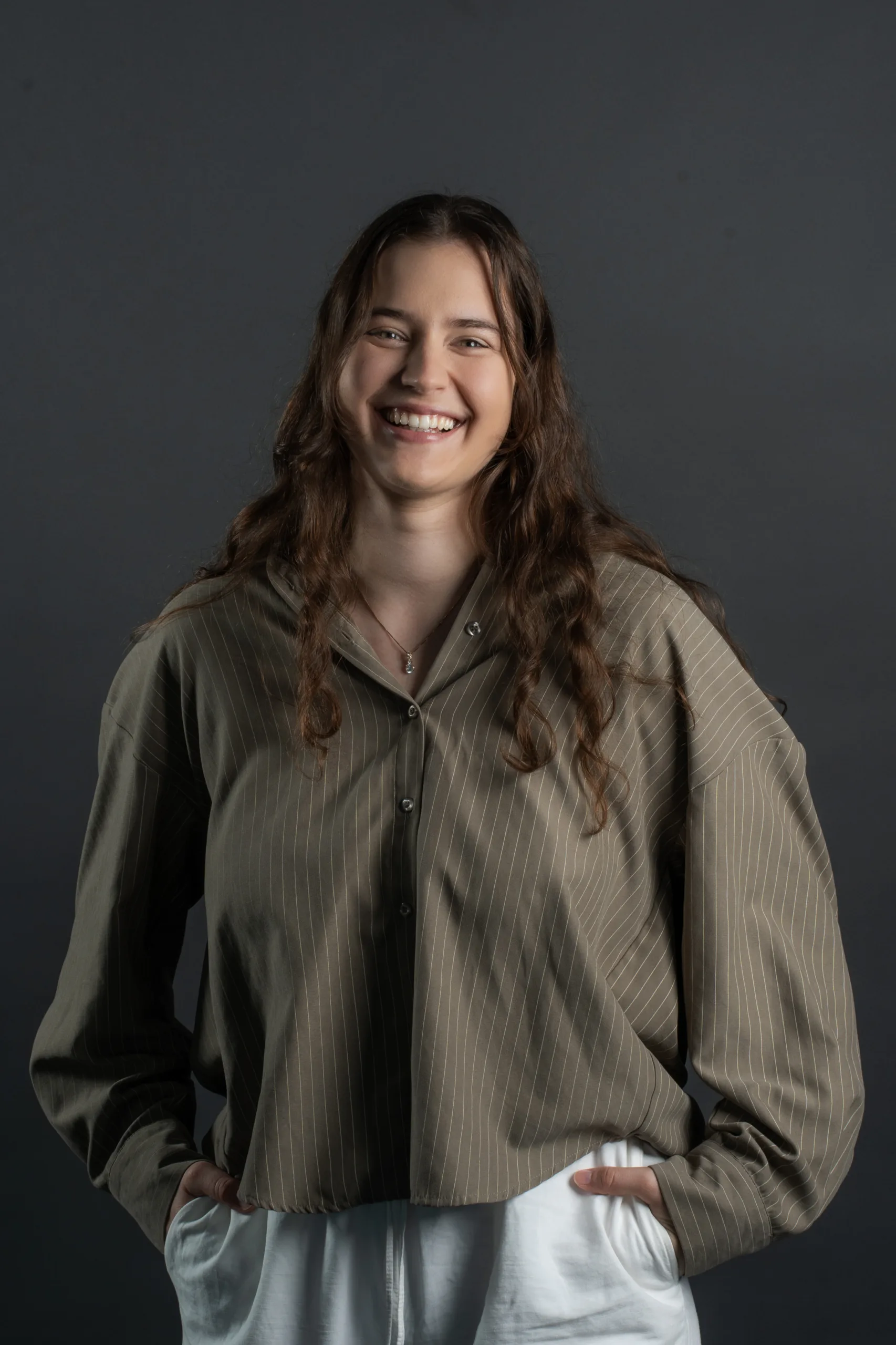 Business portrait of a team member in Berlin against a dark grey backdrop