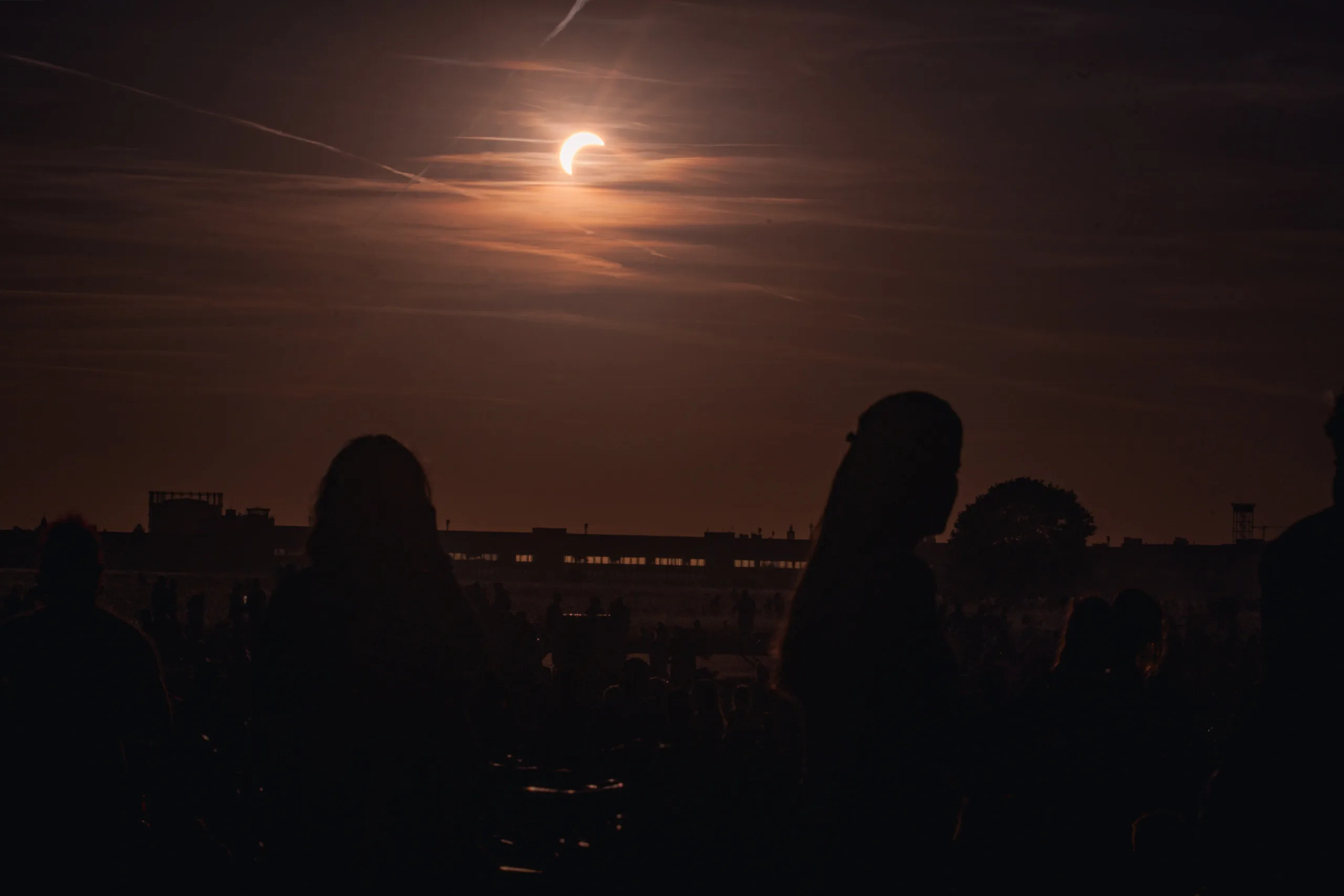 Photographing the Solar Eclipse in Berlin Fedor Vasilev Photographer In Berlin Silhouettes of people watching a partial solar eclipse in the
sky captured by Berlin-based photographer Fedor Vasilev