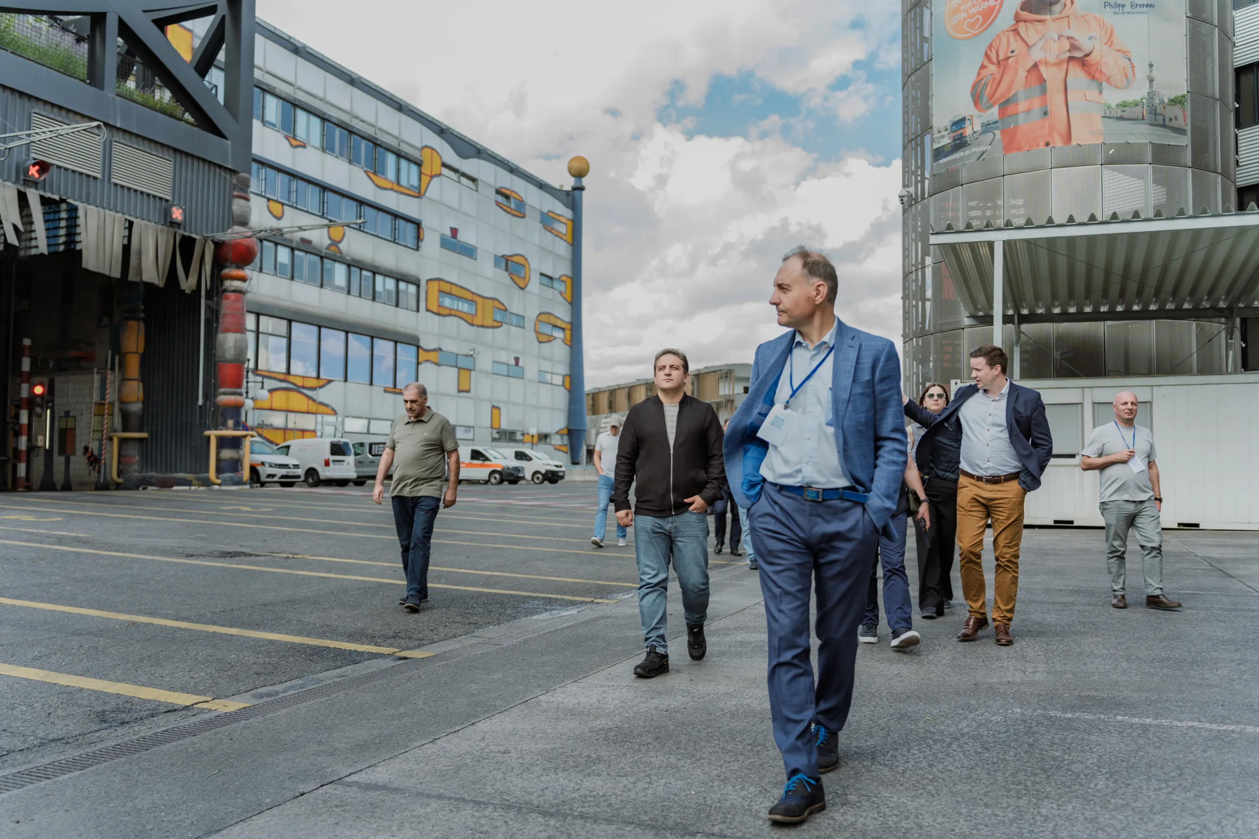 Delegates walk across an industrial courtyard near the colorful Spittelau waste incinerator in Berlin.